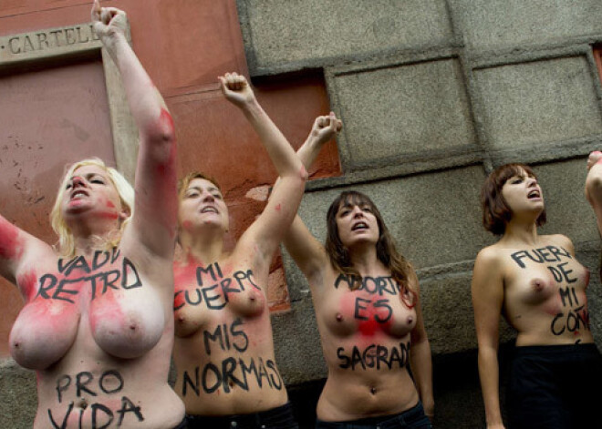 Puskailas "Femen" aktīvistes Madridē uz laiku pārtrauc aborta pretinieku demonstrāciju. FOTO