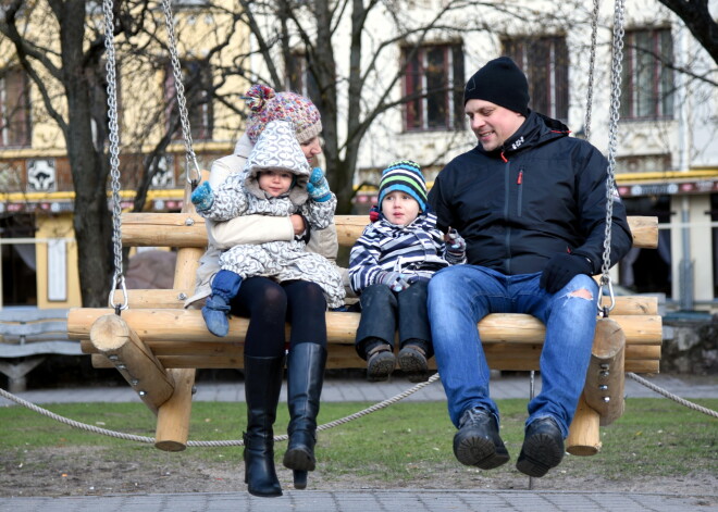 Cilvēki šūpojas "Jautrajās Lieldienu šūpolēs" Līvu laukumā.