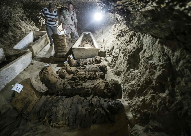 A picture taken on May 13, 2017, shows mummies lying in catacombs following their discovery in the Touna el-Gabal district of the Minya province, in central Egypt.
Egyptian archaeologists have discovered 17 non-royal mummies in the desert catacombs, an "unprecedented" find for the area south of Cairo, the antiquities ministry announced.
Along with the mummies, they found a golden sheet and two papyri in Demotic -- an ancient Egyptian script -- as well as a number of sarcophogi made of limestone and clay. / AFP PHOTO / KHALED DESOUKI