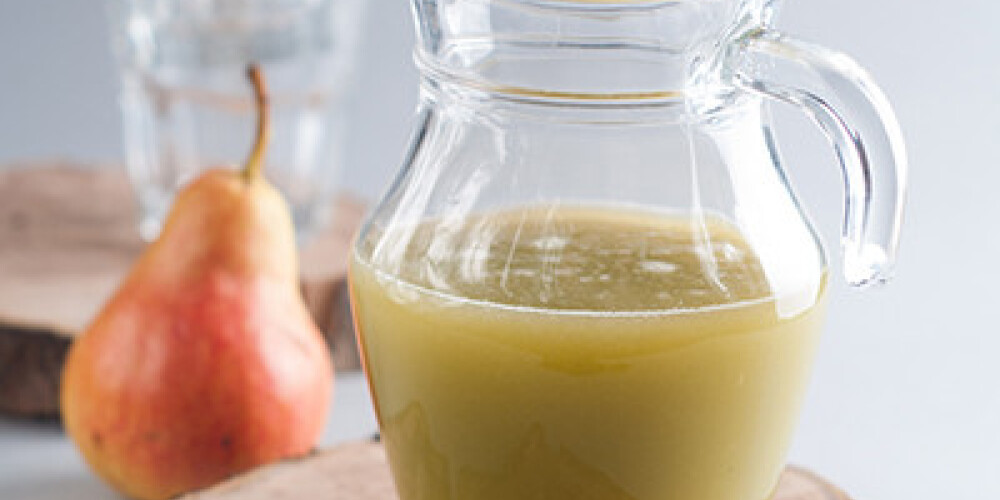 Fresh fruit juices served in glass jug, selective focus