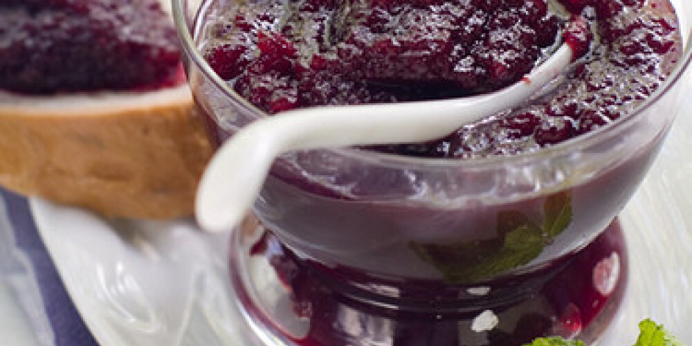 Black currant jam in glass . Selective focus