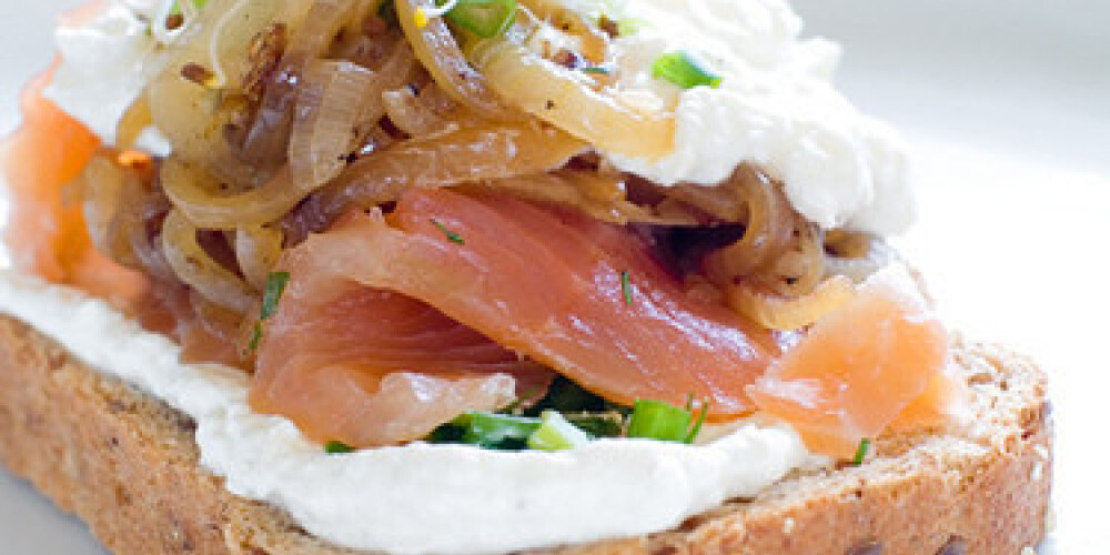 Wholegrain bread sandwich with smoked salmon, soft cheese,onion and sprouts