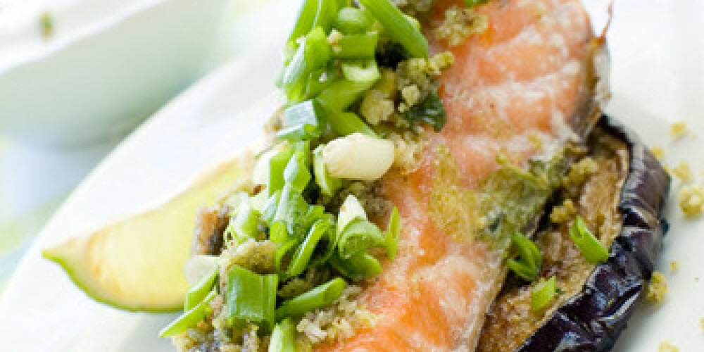 A grilled salmon fillet with grilled eggplant and wine