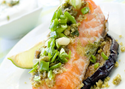 A grilled salmon fillet with grilled eggplant and wine