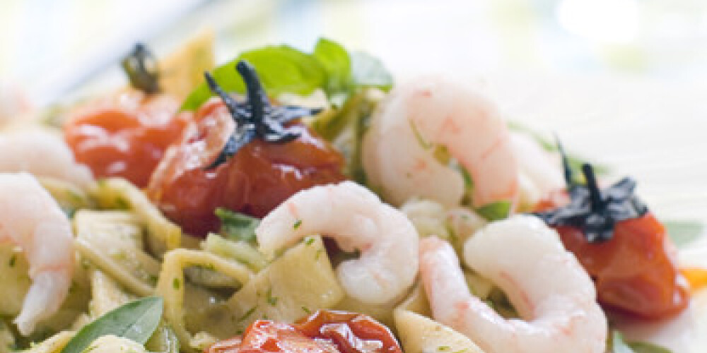 Tagliatelle with shrimp, tomato and pesto. Selective focus