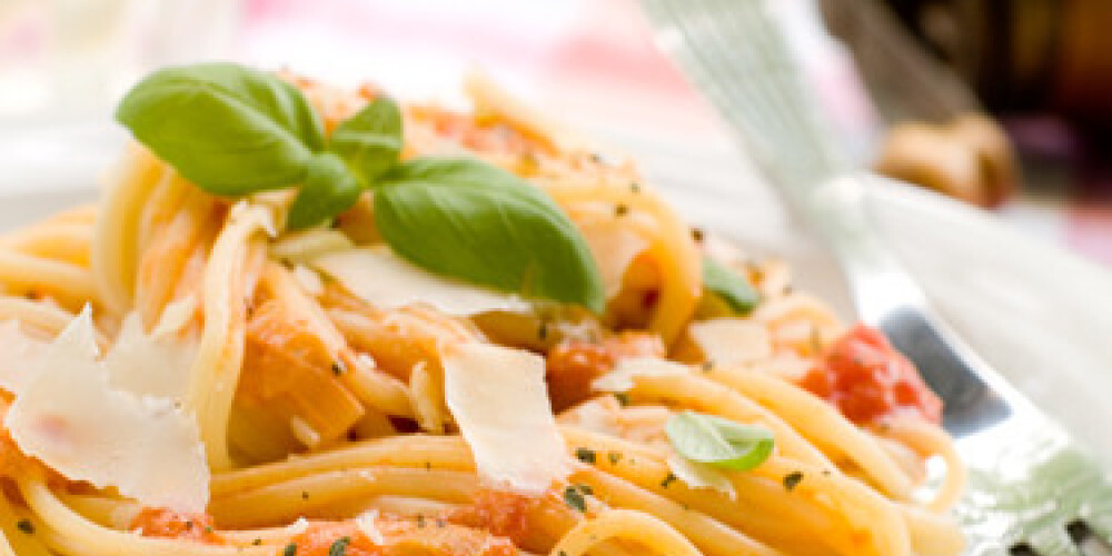 Spaghetti with a tomato sauce, cheese and a basil. Selective focus