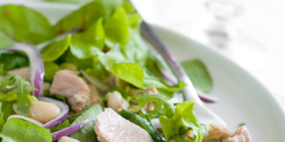 A fresh and light salad with a glass of red wine. Shallow depth of field, selective focus