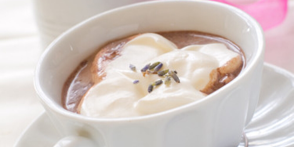 A cup of morning drink with whipped cream and lavender