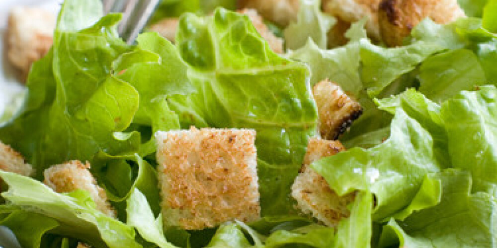 A bowl of fresh lettuce salad with crouton