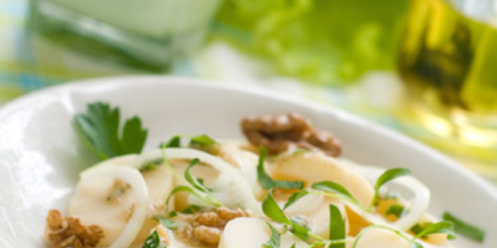 Potato salad with onion and pesto dressing 
Selective focus