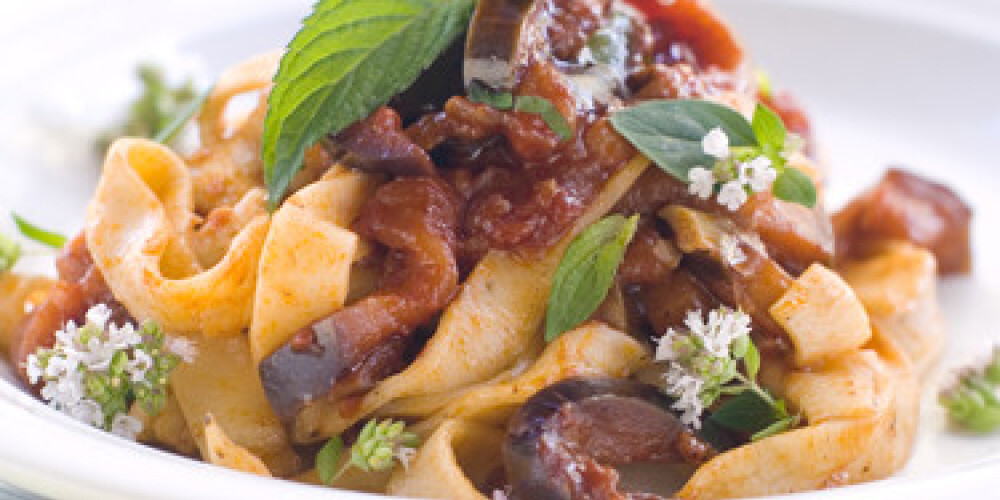 Tagliatelle with zucchini and tomato sauce and mint. Selective focus