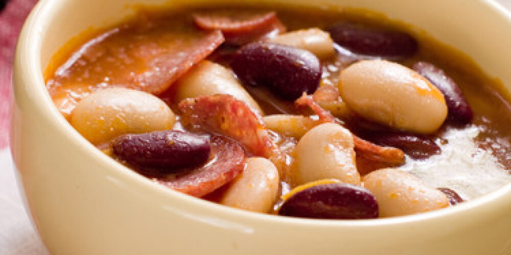 White and brown  bean soup in bowl . Selective focus