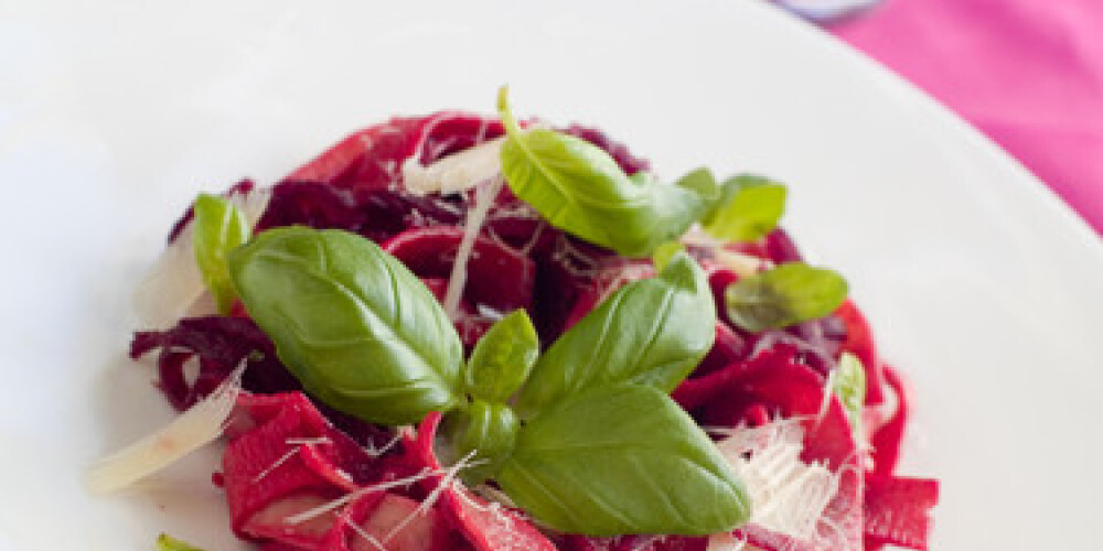 Tagliatelle with beet and cheese on plate, soft focus