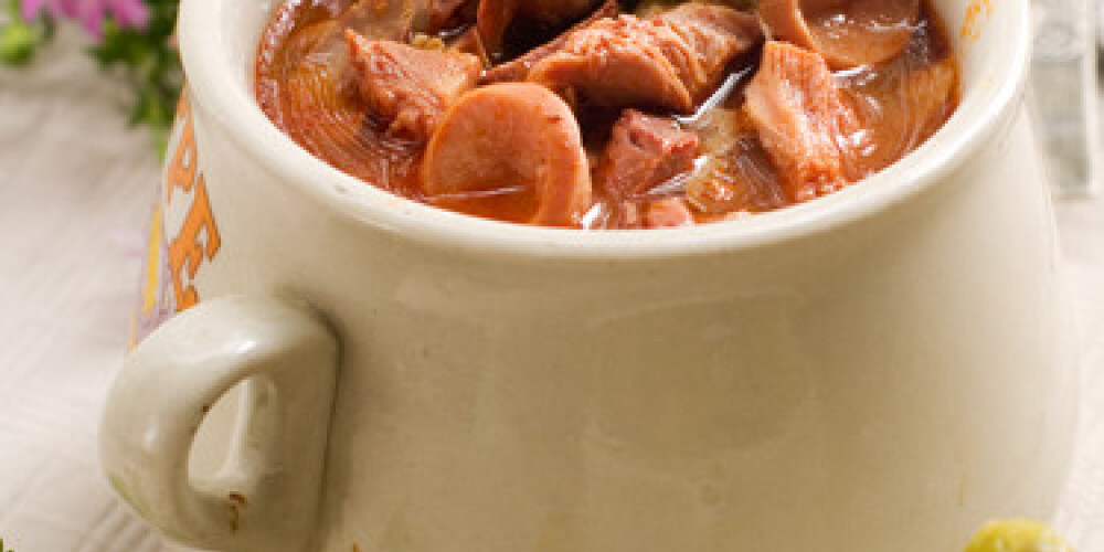 Meat soup with parsley in pot. Selective focus