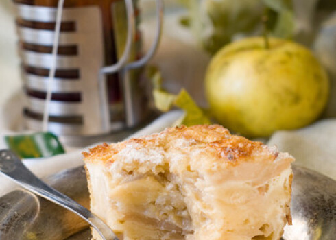 A slice of apple cake and cup of tea. Soft focus