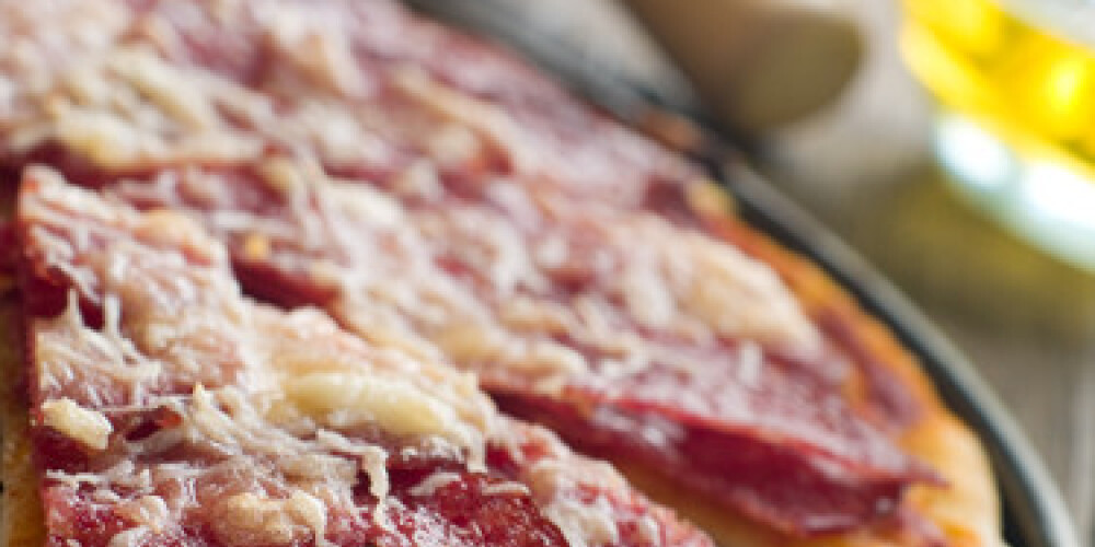 Pizza with tomato sauce, pepperoni and cheese, selective focus