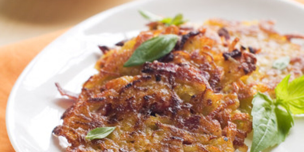 Potato pancake or rosti with basil, selective focus