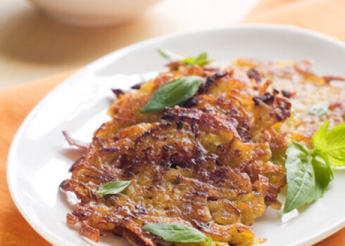 Potato pancake or rosti with basil, selective focus