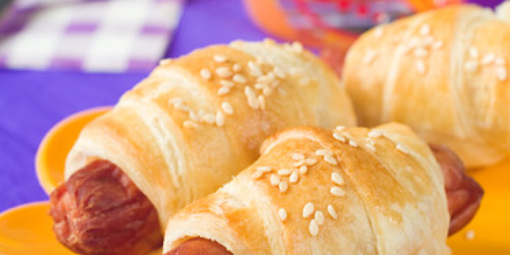 Sausage in dough for children breakfast, selective focus