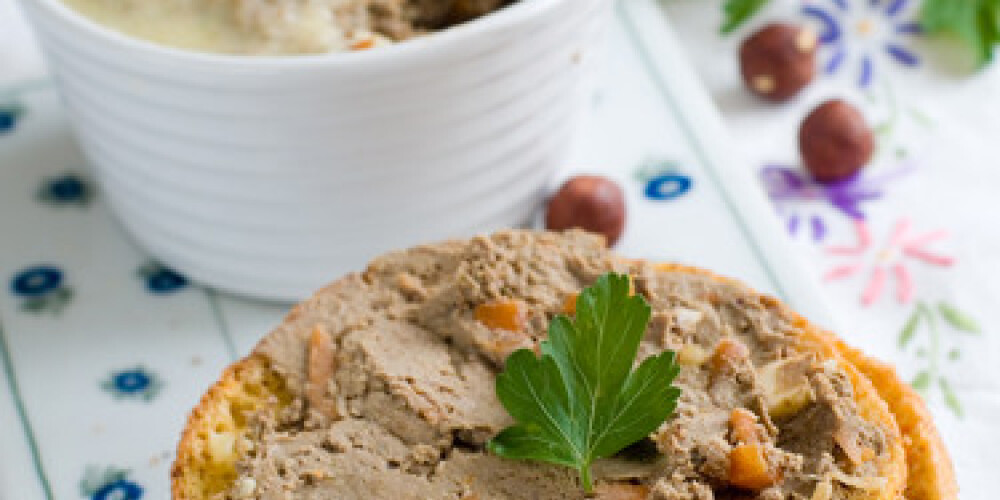 Bread with  liver pate in a white ramekin with antique silver knife.