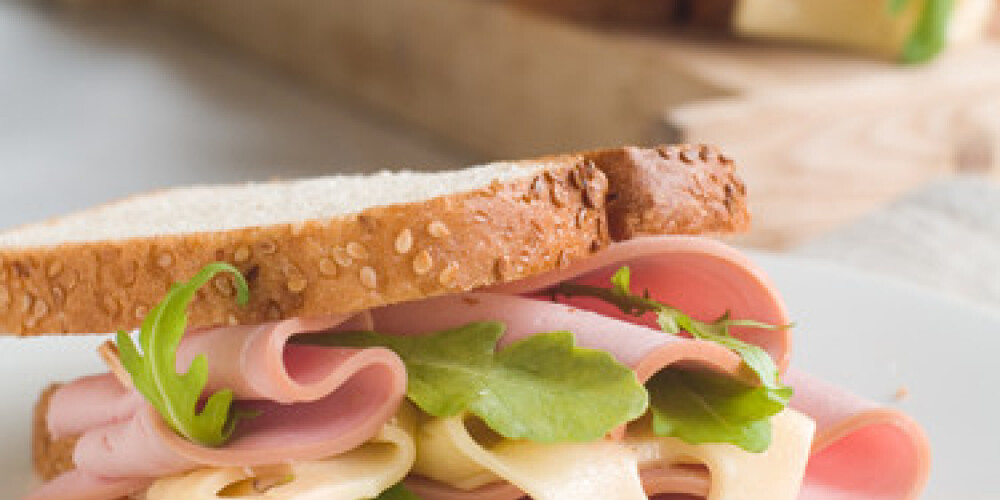 Cheese and sausage sandwich with arugula, selective focus