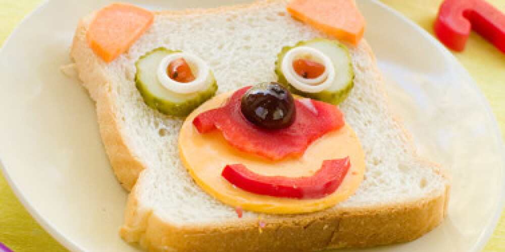 breakfast with funny sandwich for child with drink on background. Selective focus
