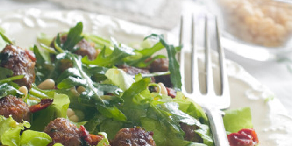 Lettuce salad with meat balls and nuts, selective focus