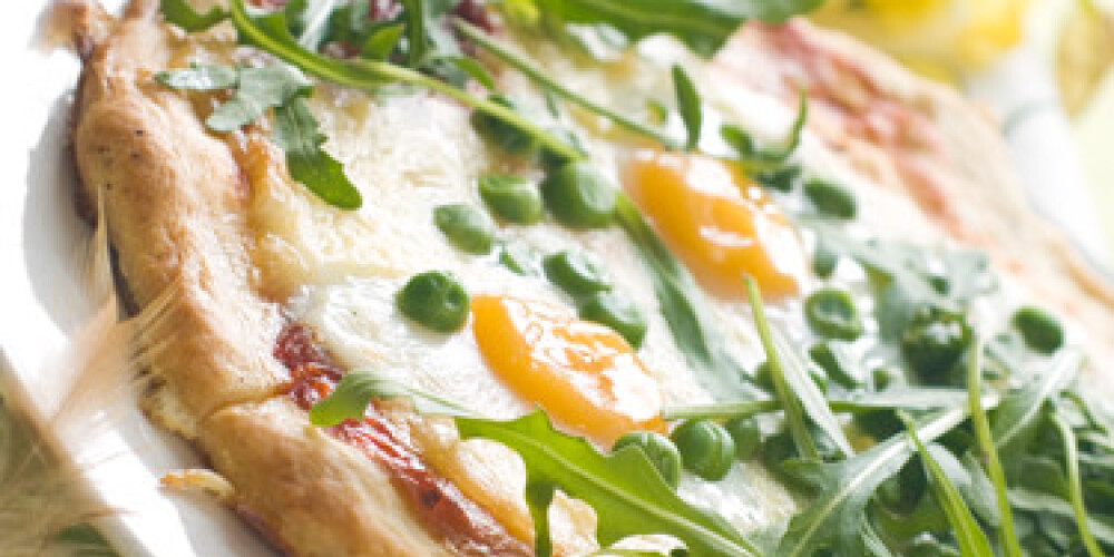 Margharita pizza with arugula and egg for breakfast, selective focus