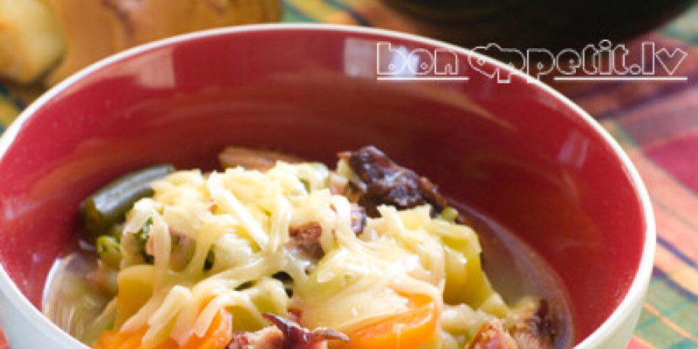 Vegetable soup with cheese on wooden board, selective focus