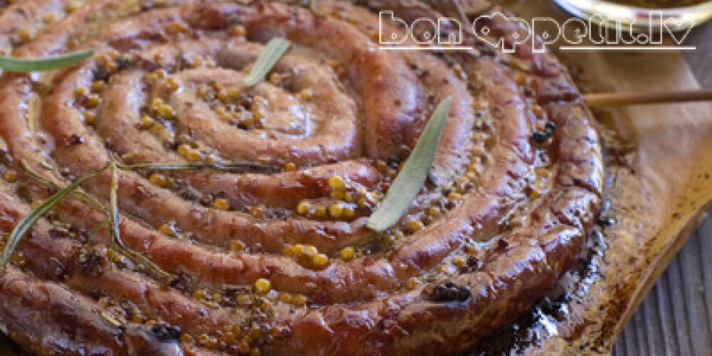 Grilled sausage (kielbasa) ring on wooden board, selective focus