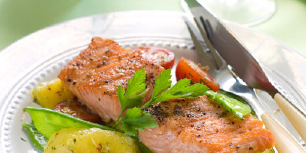 grilled salmon with potato, pea and tomato, selective focus
