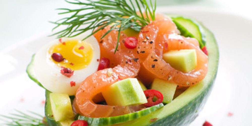 Salmon, avocado and egg salad in avocado, selective focus