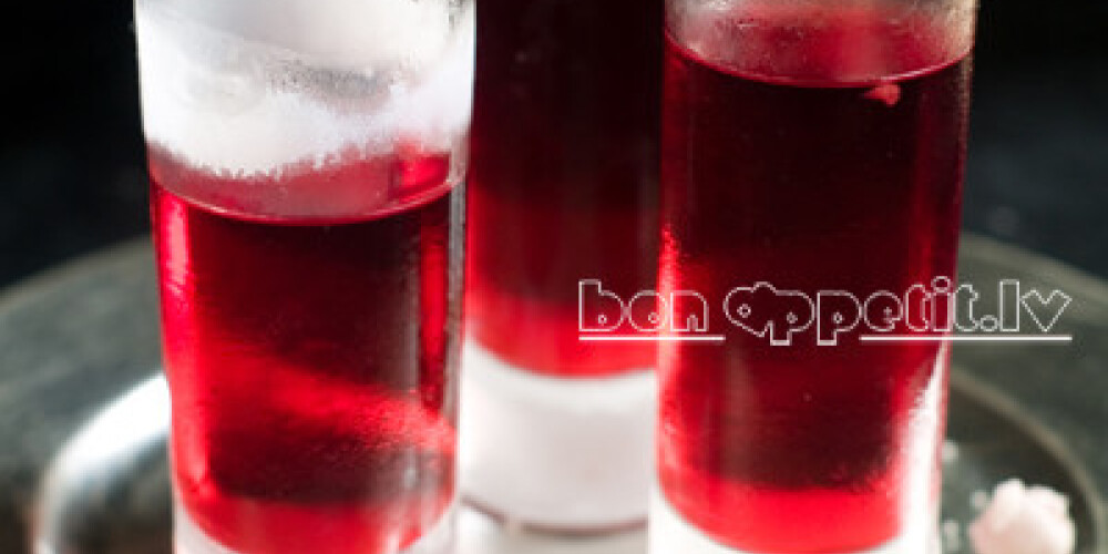 Hard liquor shots with cranberry, selective focus