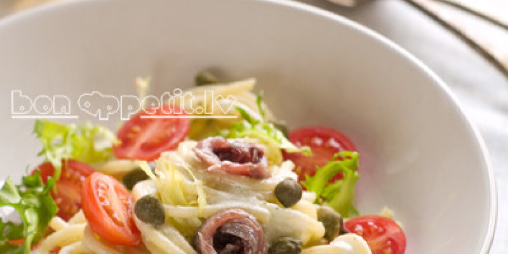 Pasta with frsh tomatoes, anchovy and capers, selective focus