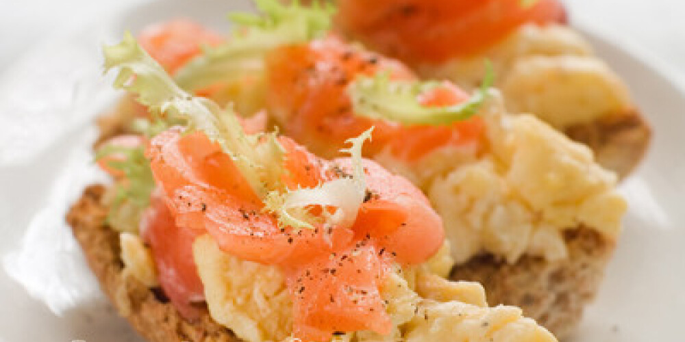 Bread with scrambled egg and salmon, selective focus