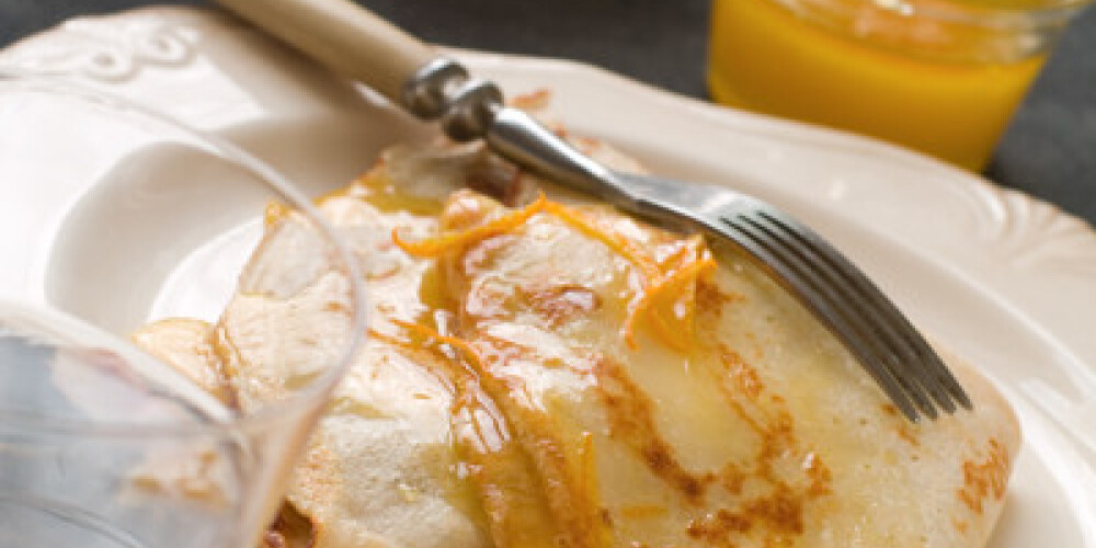 Crepes with honey or sirup and orange, selective focus