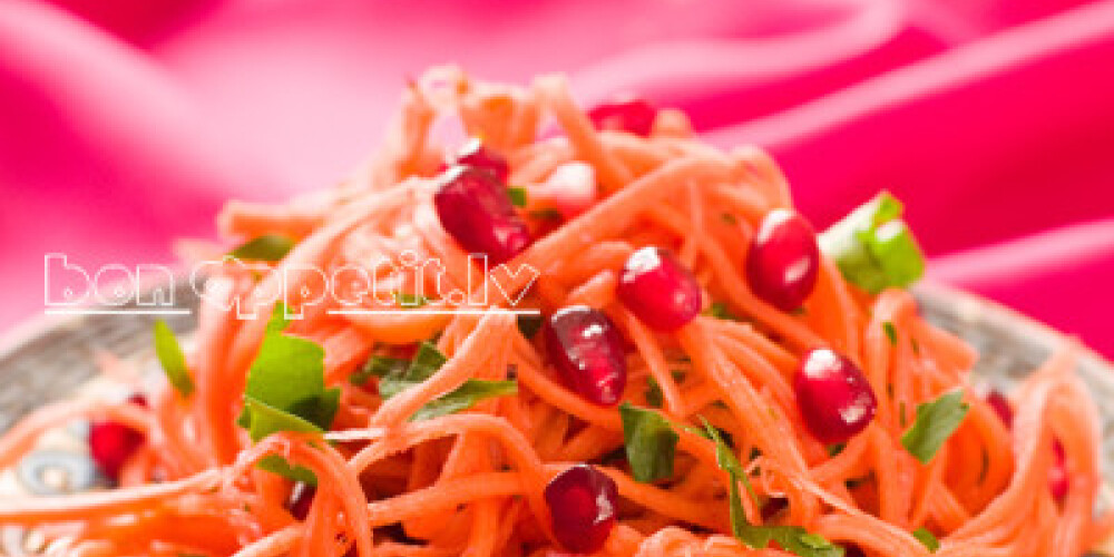 Carrot salad with pomegranate seeds, selective focus