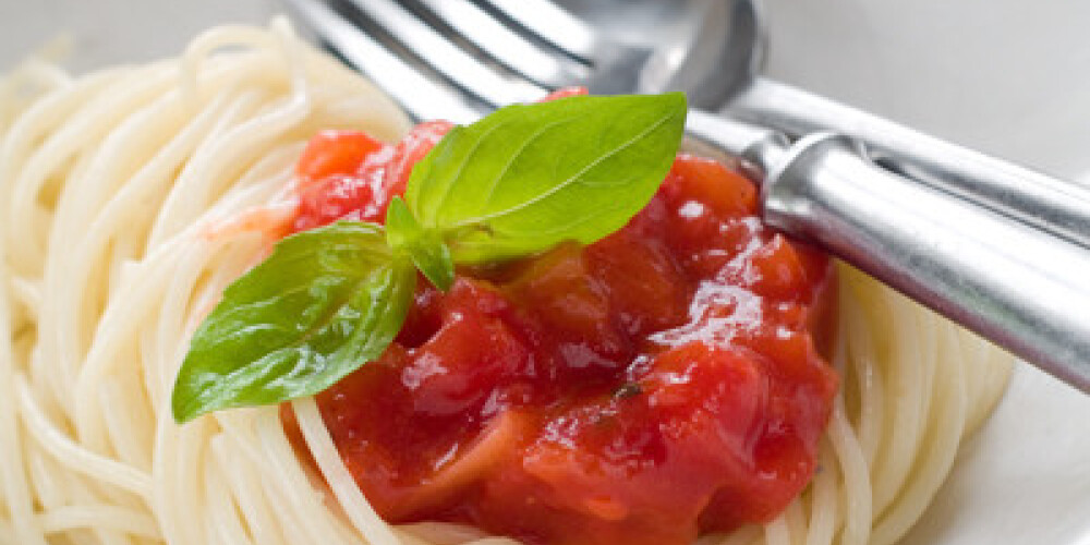 Pasta with tomato sauce and basil, selective focus