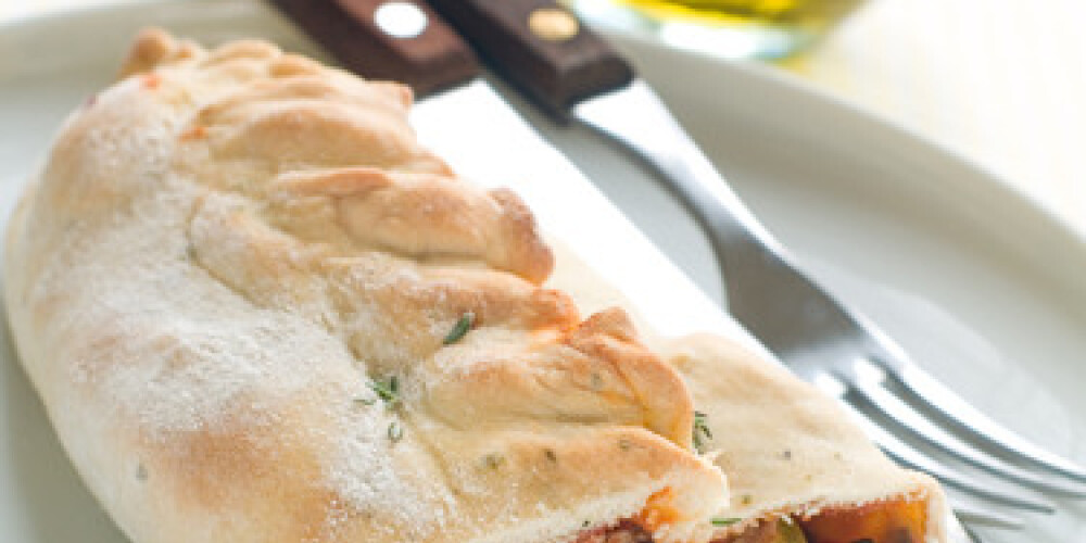 Calzone pizza with tuna on a plate, selective focus