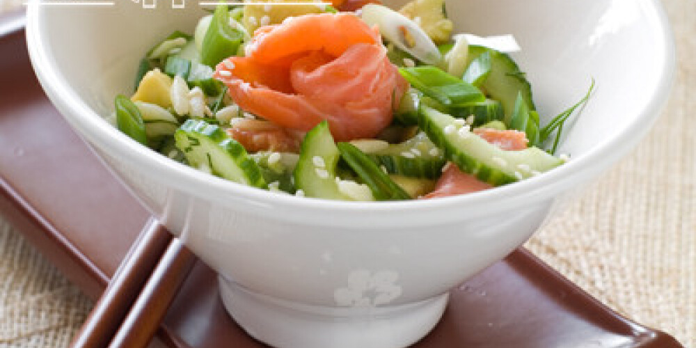 Fresh cucumber salad with salmon and sesame seeds, selective focus