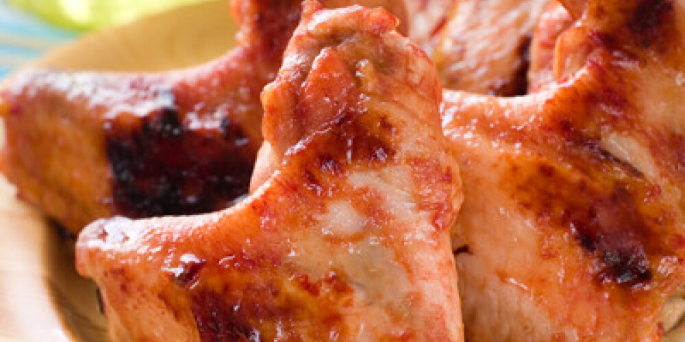 Chicken wings on wooden plate, selective focus