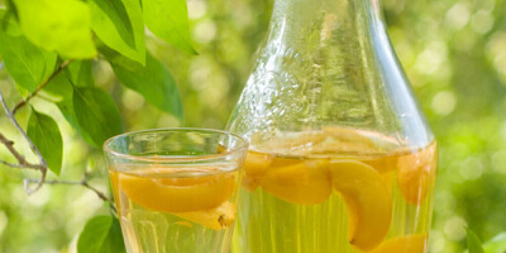 A glass of fruit liqueur  on natural background, selective focus