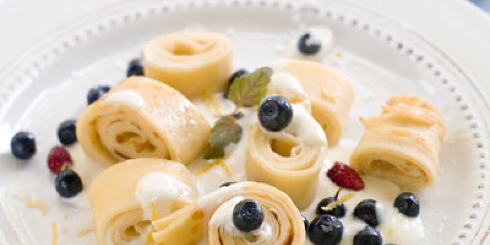 Pancake rolls with sauce and fresh berry, selective focus