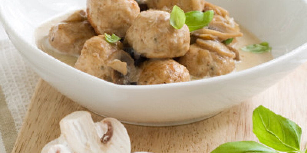 Meatballs with mushroom sauce and basil, selective focus