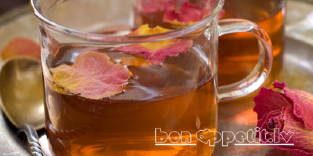 A cup of floral tea with rose petal, selective focus