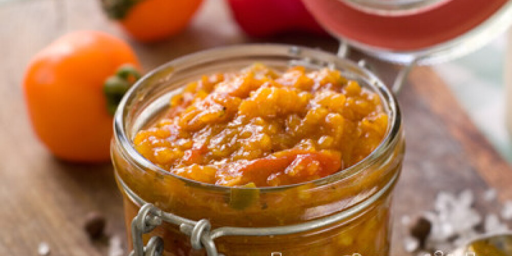 Tomato, pepper and zucchini preserves in glass jar, selective focus