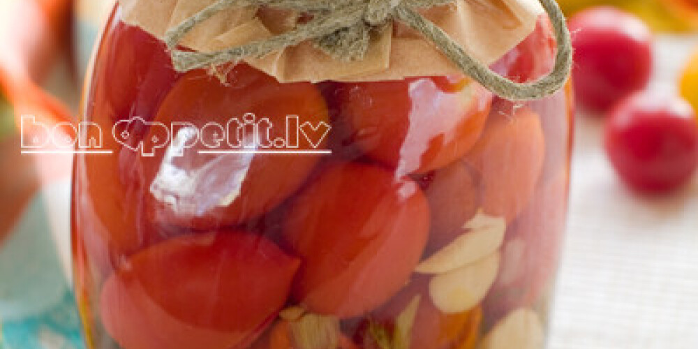 Preserved tomato in glass jar, selective focus