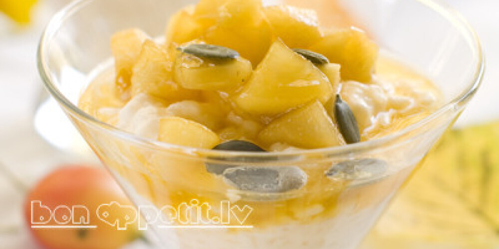 Creamed rice pudding with apple and pumpkin seed, selective focus