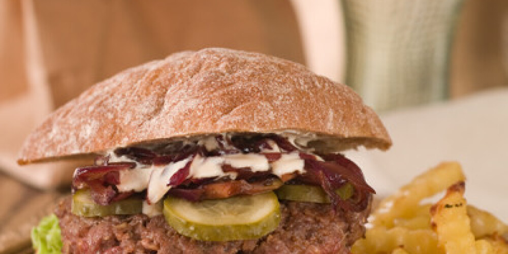 Hamburger with cucumber and onion, selective focus