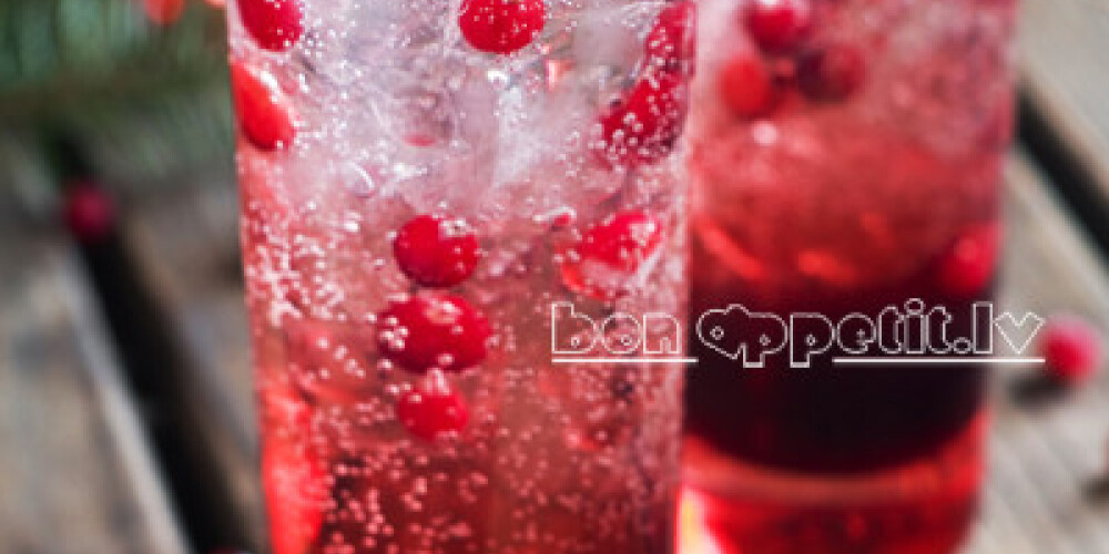 Refreshing cocktail with sparkling water with ice and cranberry, selective focus